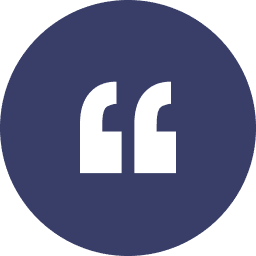 A white quotation mark symbol inside a dark blue circle.